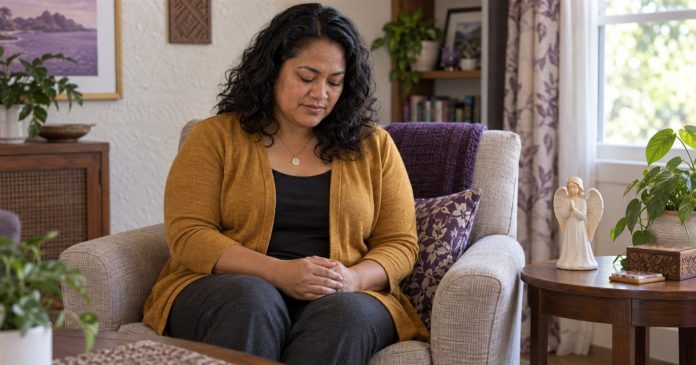 Woman pausing for personal prayer in a living room beside a ceramic angel figurine