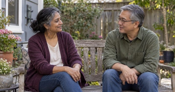 Two older adults having a relaxed conversation on a garden bench at home