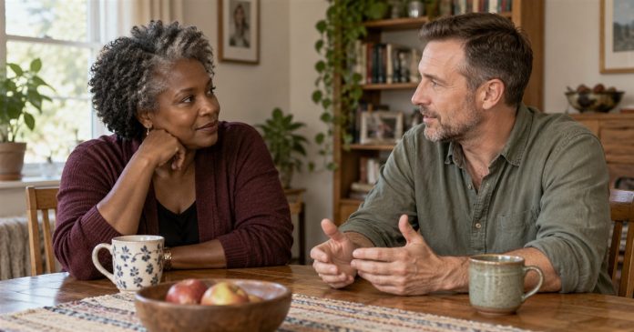 Two adults having a calm attentive conversation at a home dining table