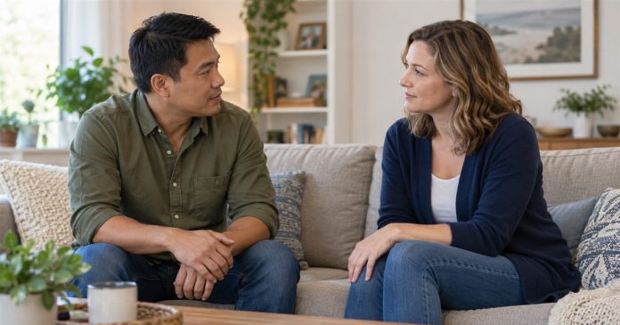 Two adults having an attentive conversation on a sofa at home