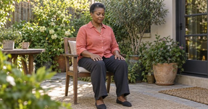 Spiritual meditation in a home garden Woman seated quietly on a chair in her home garden